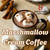 Java Junkies Marshmallow Cream Coffee. Tall mug of creamy coffee with 3 large marshmallows surrounded by sticks of cinnamon and other large marshmallows.
