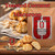 Java Junkies Toasted Coconut Macaroon Coffee. Tall stack of golden toasted coconut macaroons on a wood shelf next to a bag of coffee..