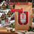 Java Junkies Christmas Coffee Blend bag sitting on a shelf with a Christmas village design behind it.