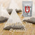A prominent mesh pyramid tea bag filled with dark tea leaves resting on a woven mat, accompanied by a retail packaging pouch.