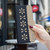 iPhone 17 Pro Max Splicing Color Hollow Flower Pattern RFID Leather Phone Case - Black