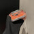 iPhone 17 Pro Max Gilded Colorful Shell Patterned TPU+IMD Phone Case with Glitter Magnetic Holder - Orange