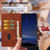 iPhone 17 Cherry Blossoms Embossed Leather Phone Case - Brown