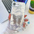 iPhone 17e / 16e Plating Glitter Lens Film Texture Butterfly Holder Wristband Phone Case - White Feathers