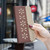 iPhone 18 Pro / 17 Pro Splicing Color Hollow Flower Pattern RFID Leather Phone Case - Brown