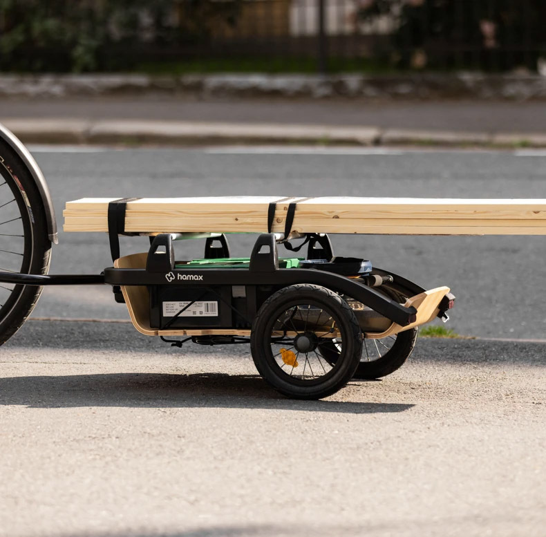 Hamax Venture bike trailer carrying timber planks secured with straps