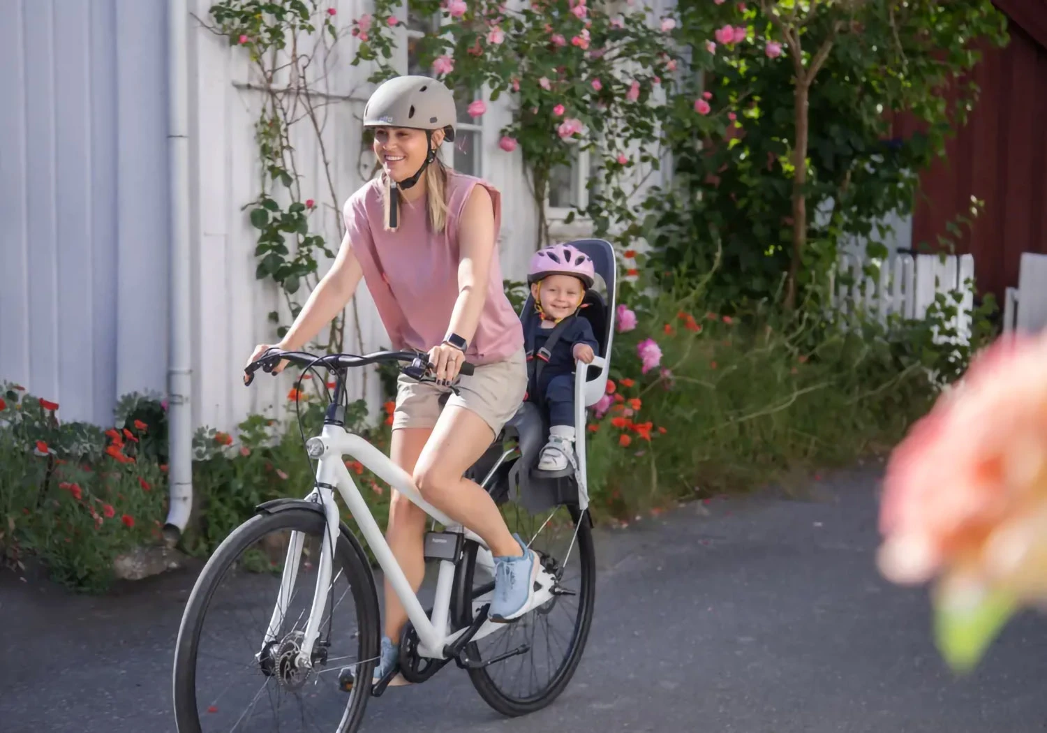 Parent cycling with child seated in Hamax Caress frame-mounted bike seat
