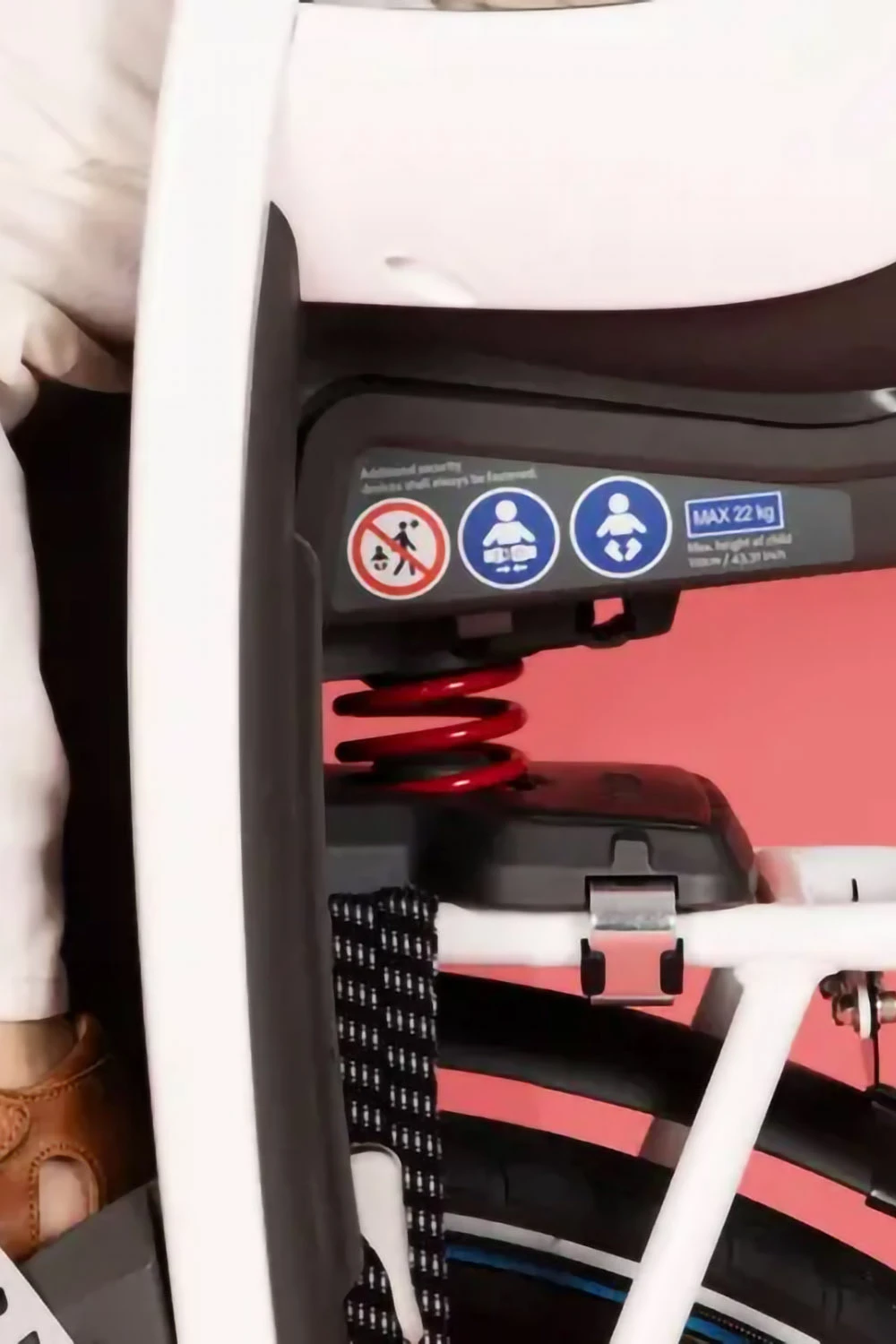 Close-up of Hamax Caress rack-mounted bike seat showing built-in suspension system