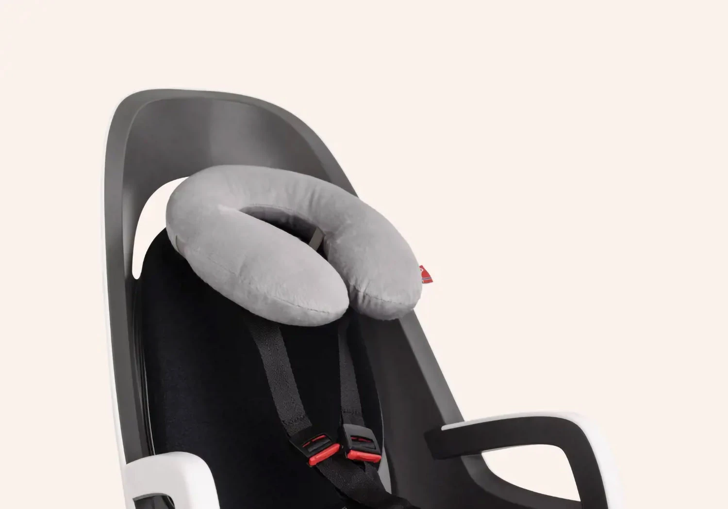 Hamax Caress frame-mounted bike seat with neck pillow accessory fitted to the safety harness