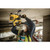 person hammer drilling into concrete ceiling