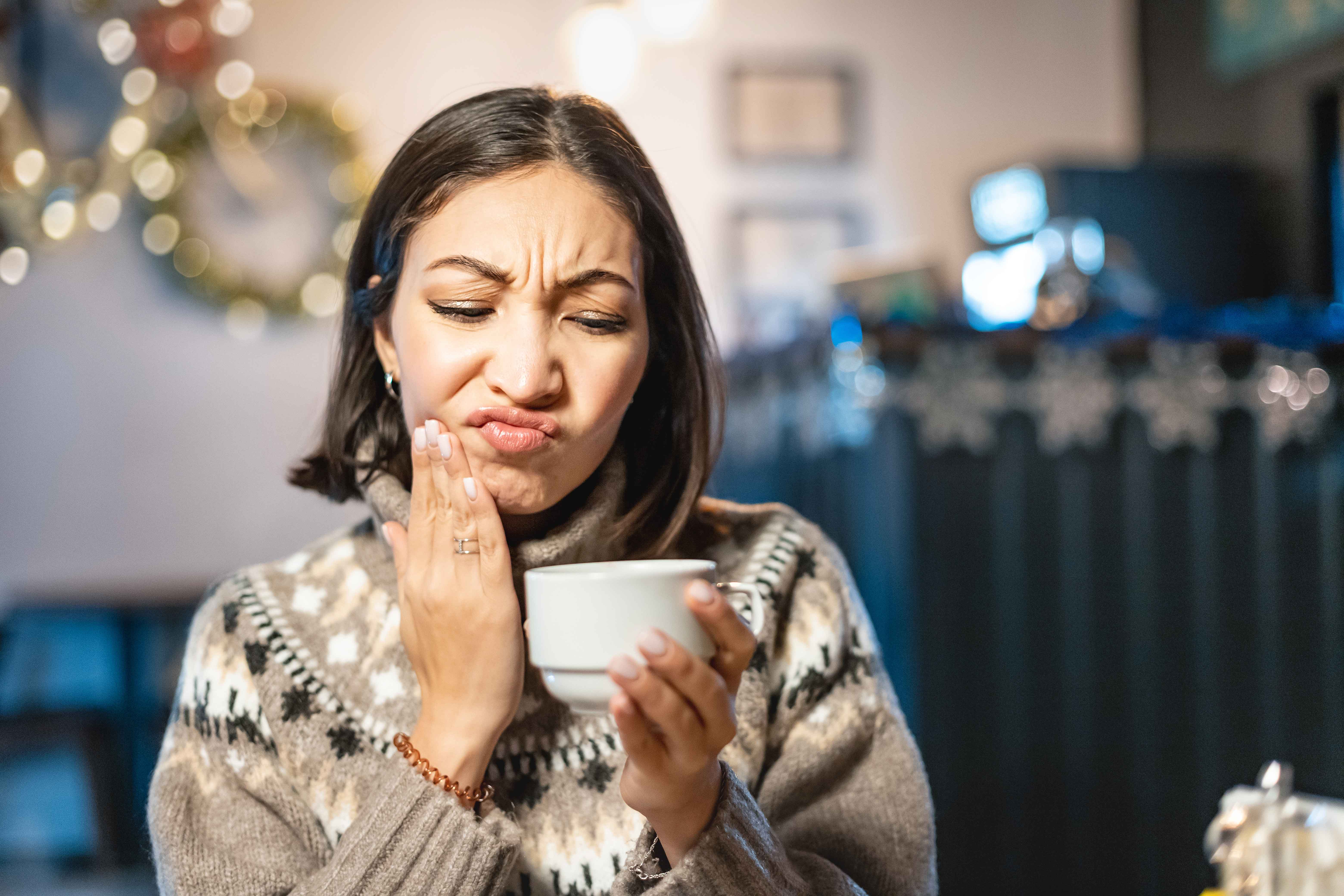 Woman experiencing tooth sensitivity