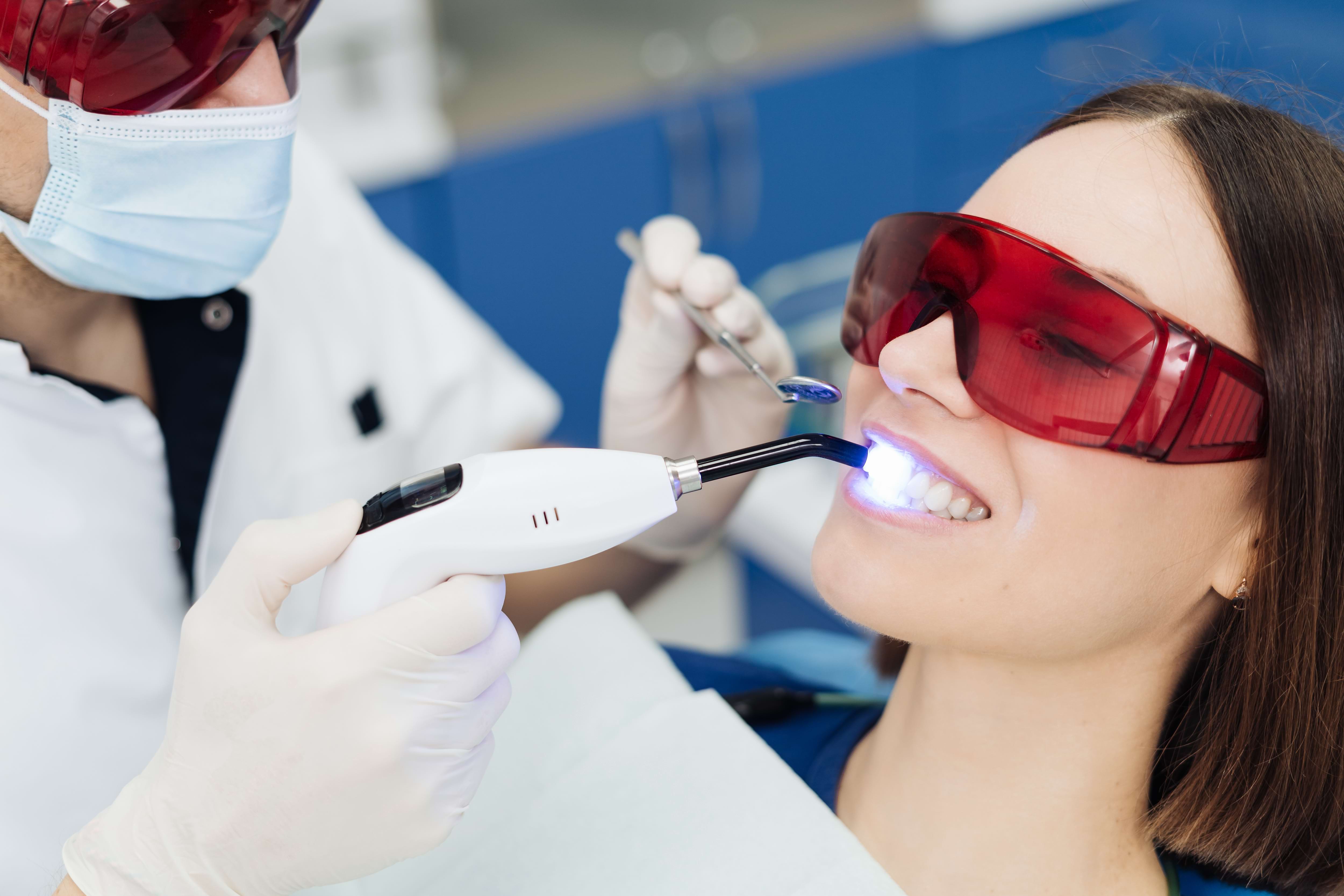 Woman getting professional teeth whitening