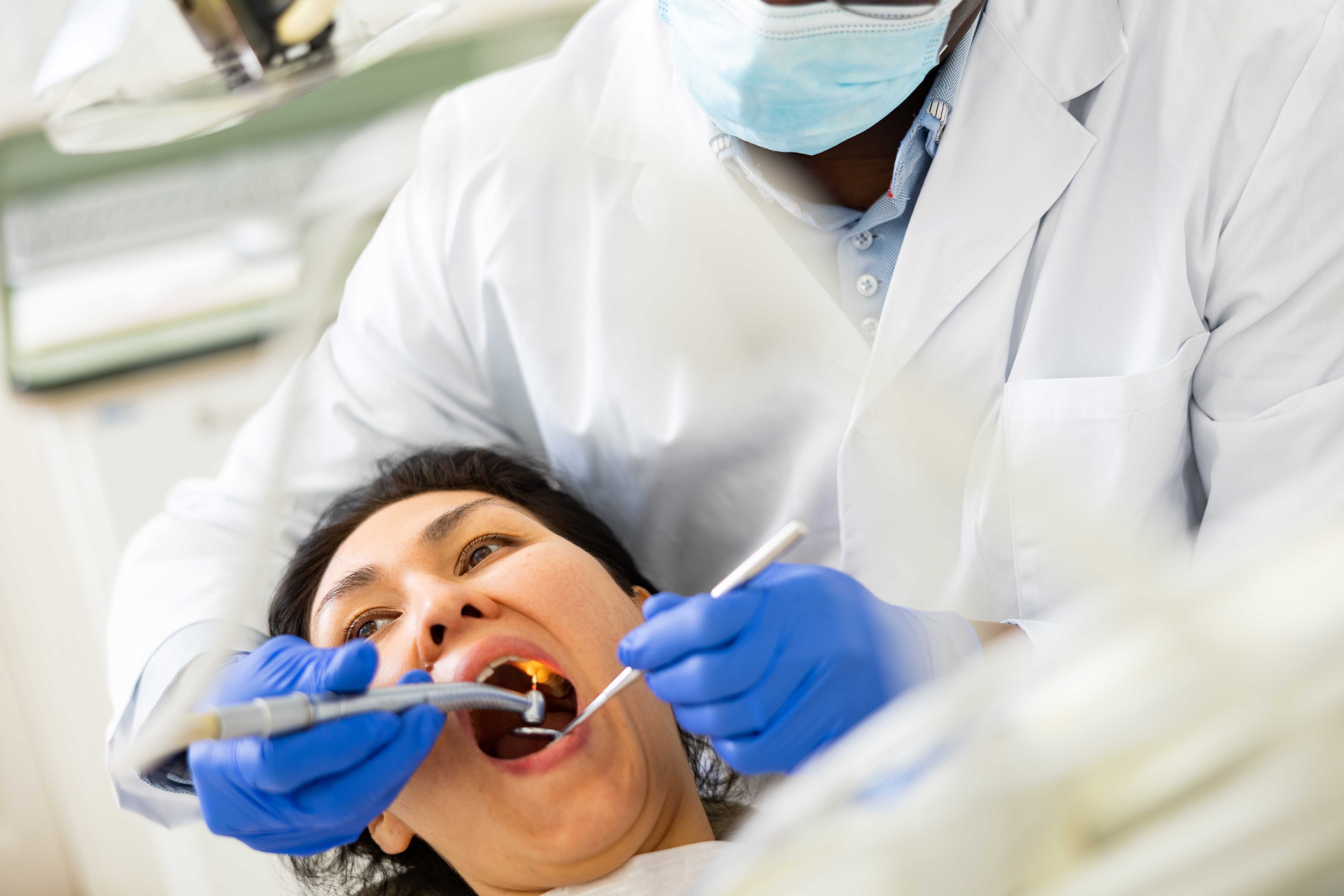 Woman getting a dental treatment for tooth pain relief
