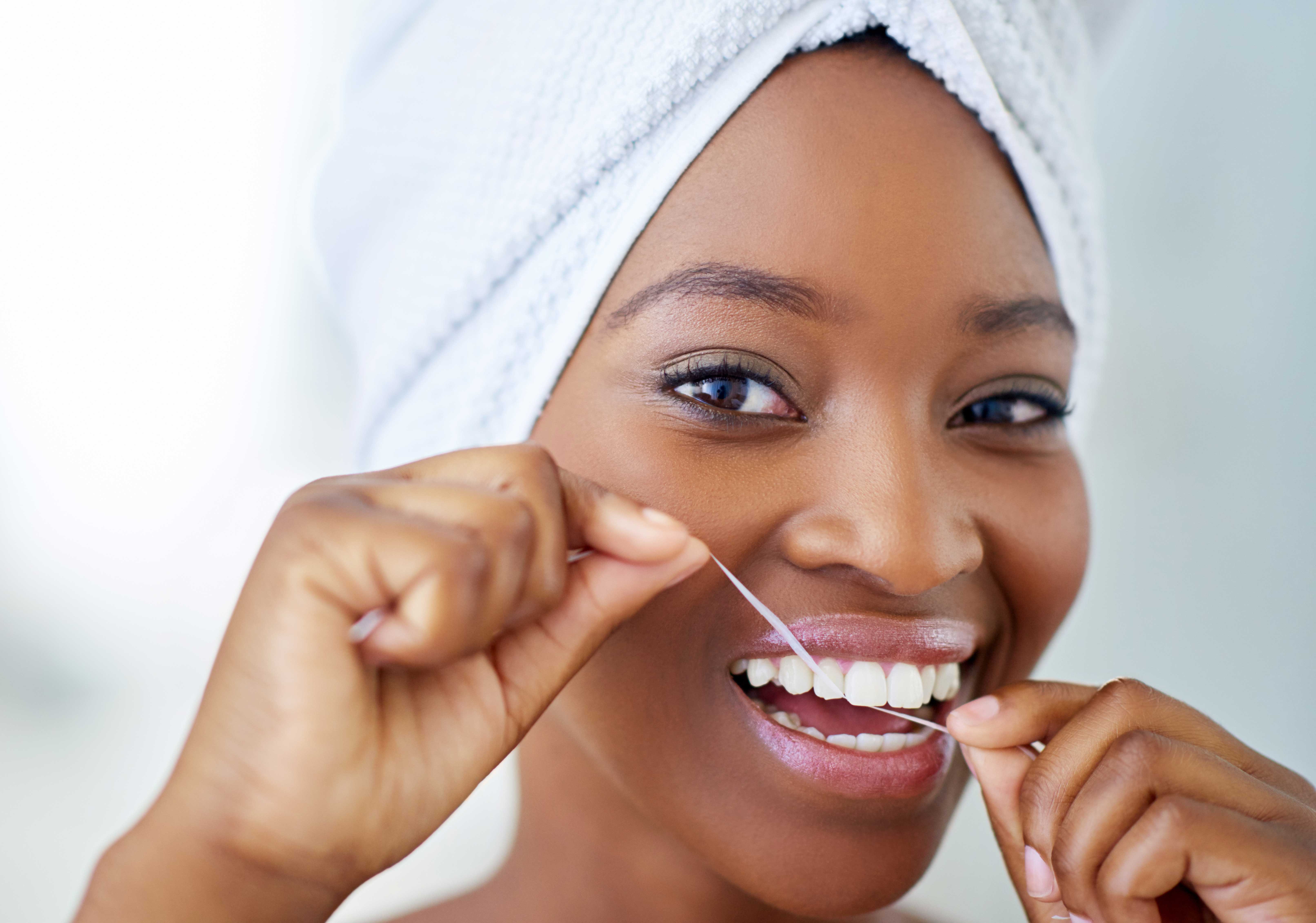 Woman flossing between her teeth