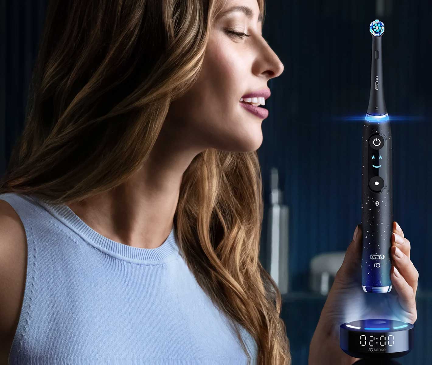 Woman holding an Oral-B toothbrush