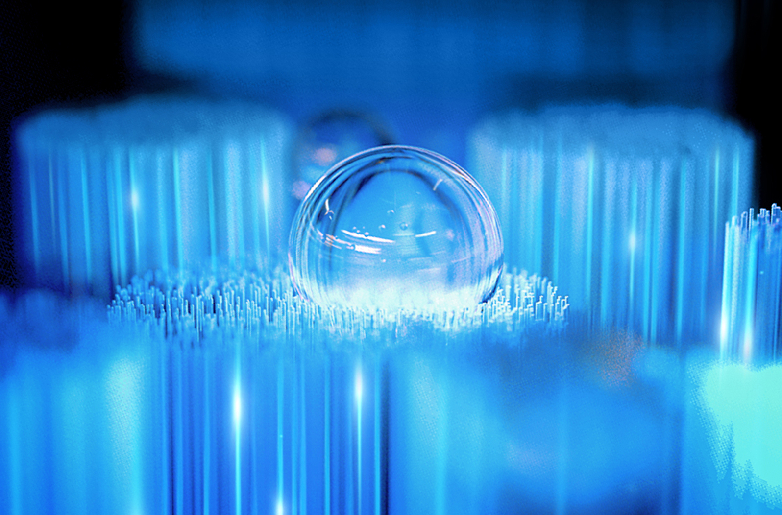 Macro shot of an Oral-B iO brush head cradling a glass marble to show how bristles conform to tooth contours.