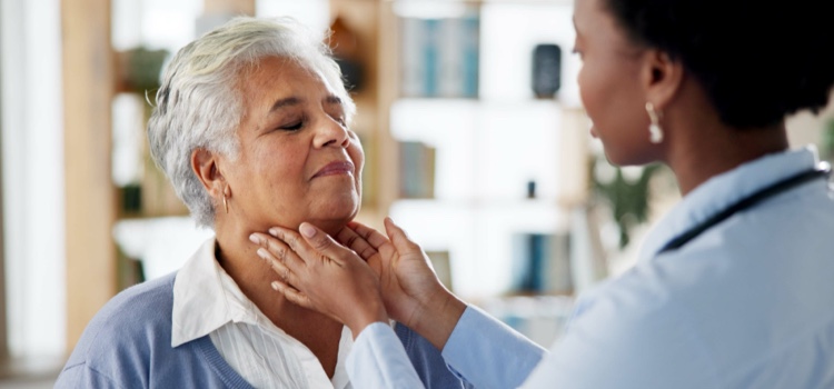 Doctor examining elderly female patient.