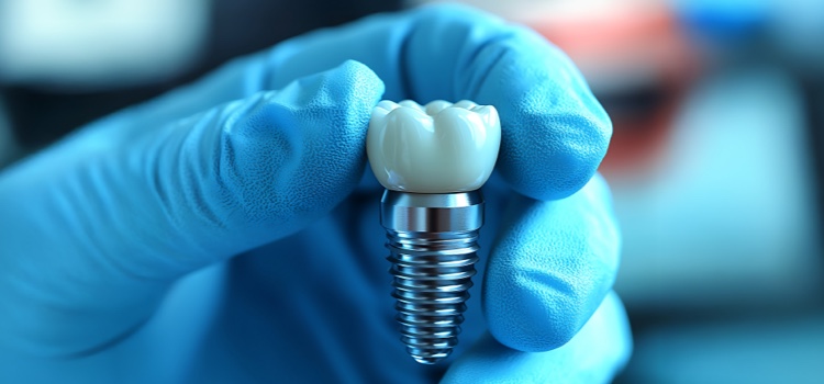 Dental technician examining a dental implant