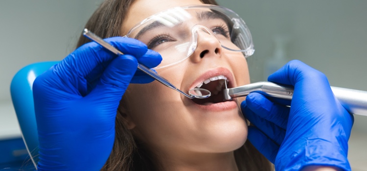 Female patient being examined at dental clinic