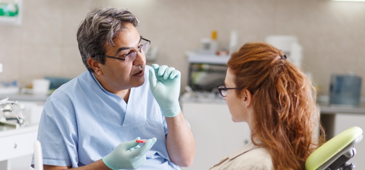 Dentist explaining endodontic retreatment to patient