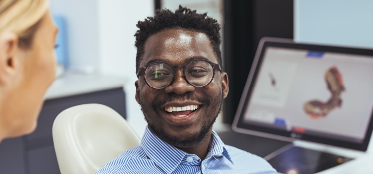 Smiling male patient with dentist.