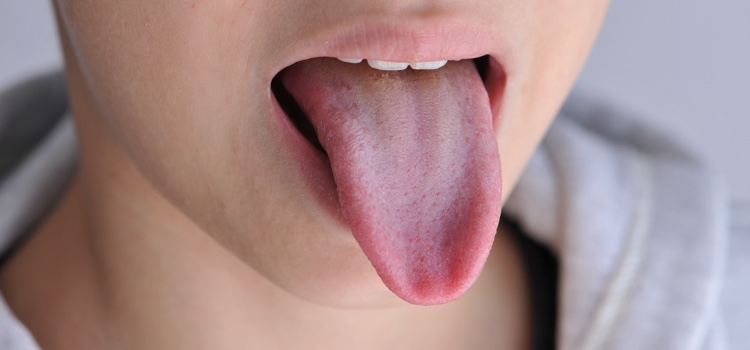 Young boy sticking his tongue out.
