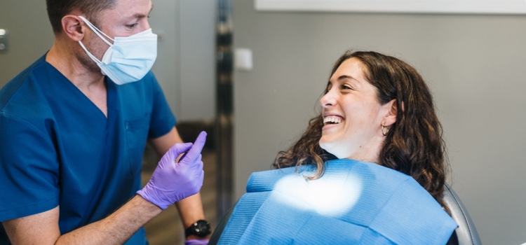 Male dentist discussing oral health with female patient