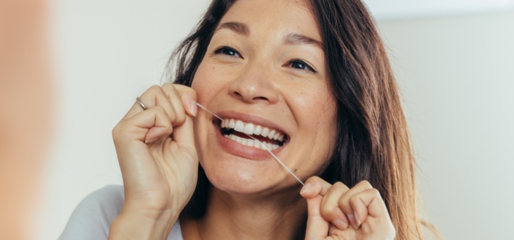 Woman flossing her teeth