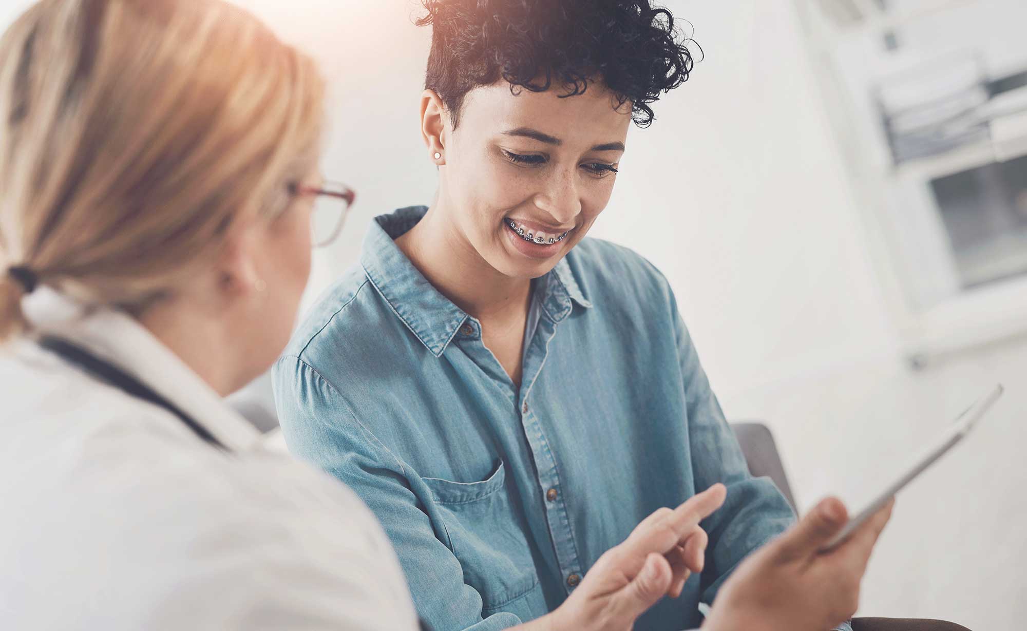 A patient in a dentist's office reviewing her options with her dentist