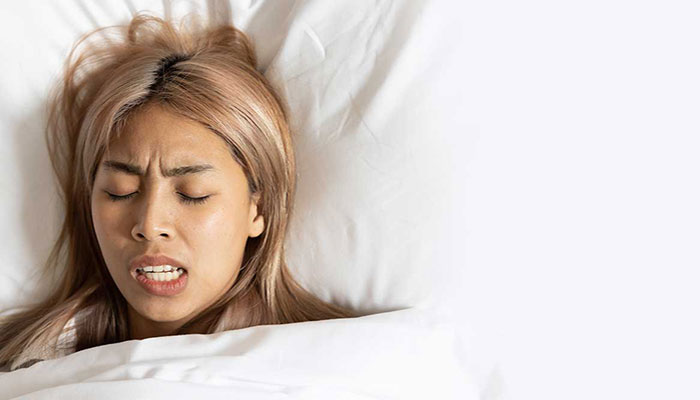 Woman sleeping and grinding her teeth Woman sleeping and grinding her teeth