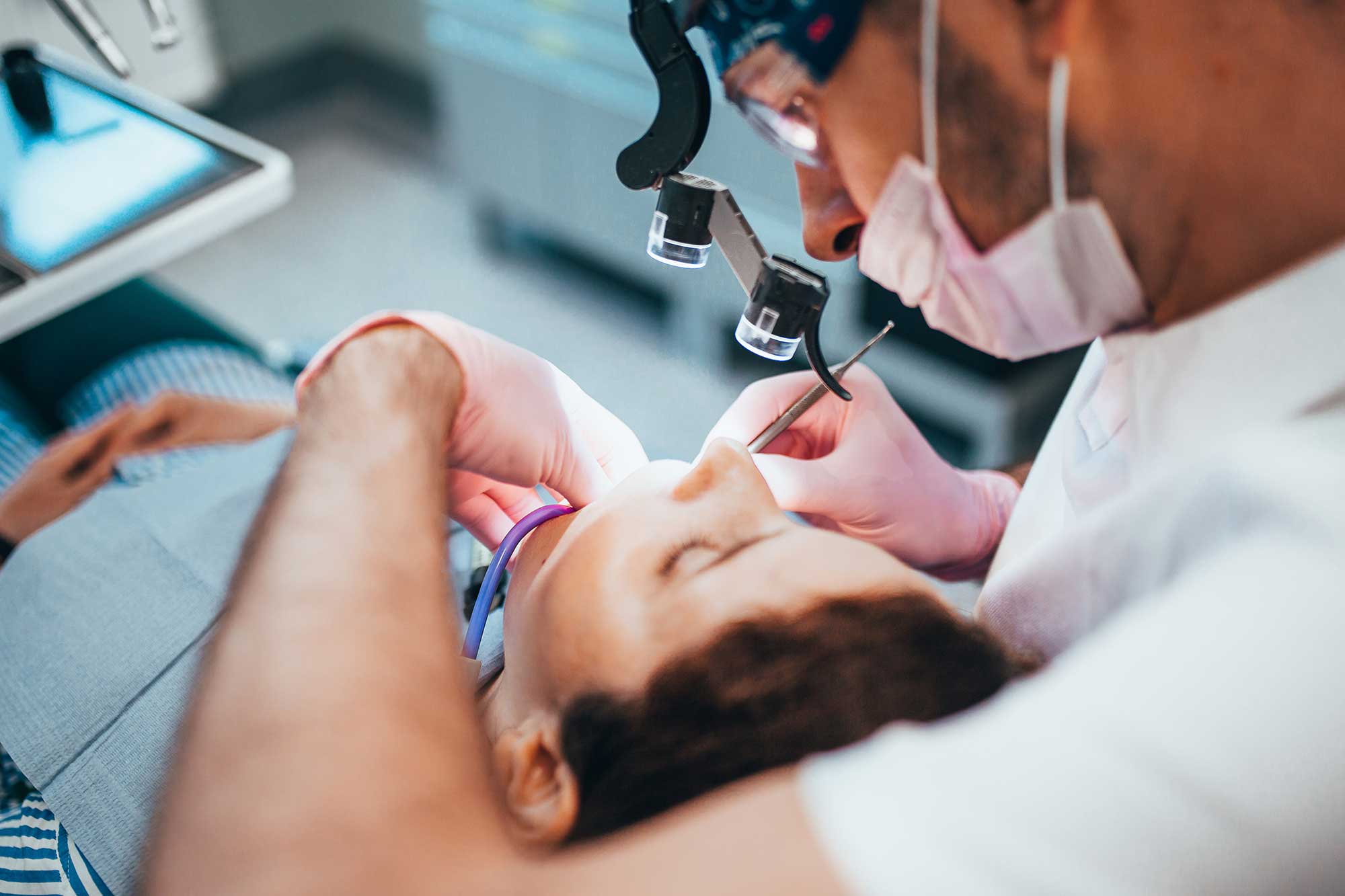 Dentist probing a patient’s teeth