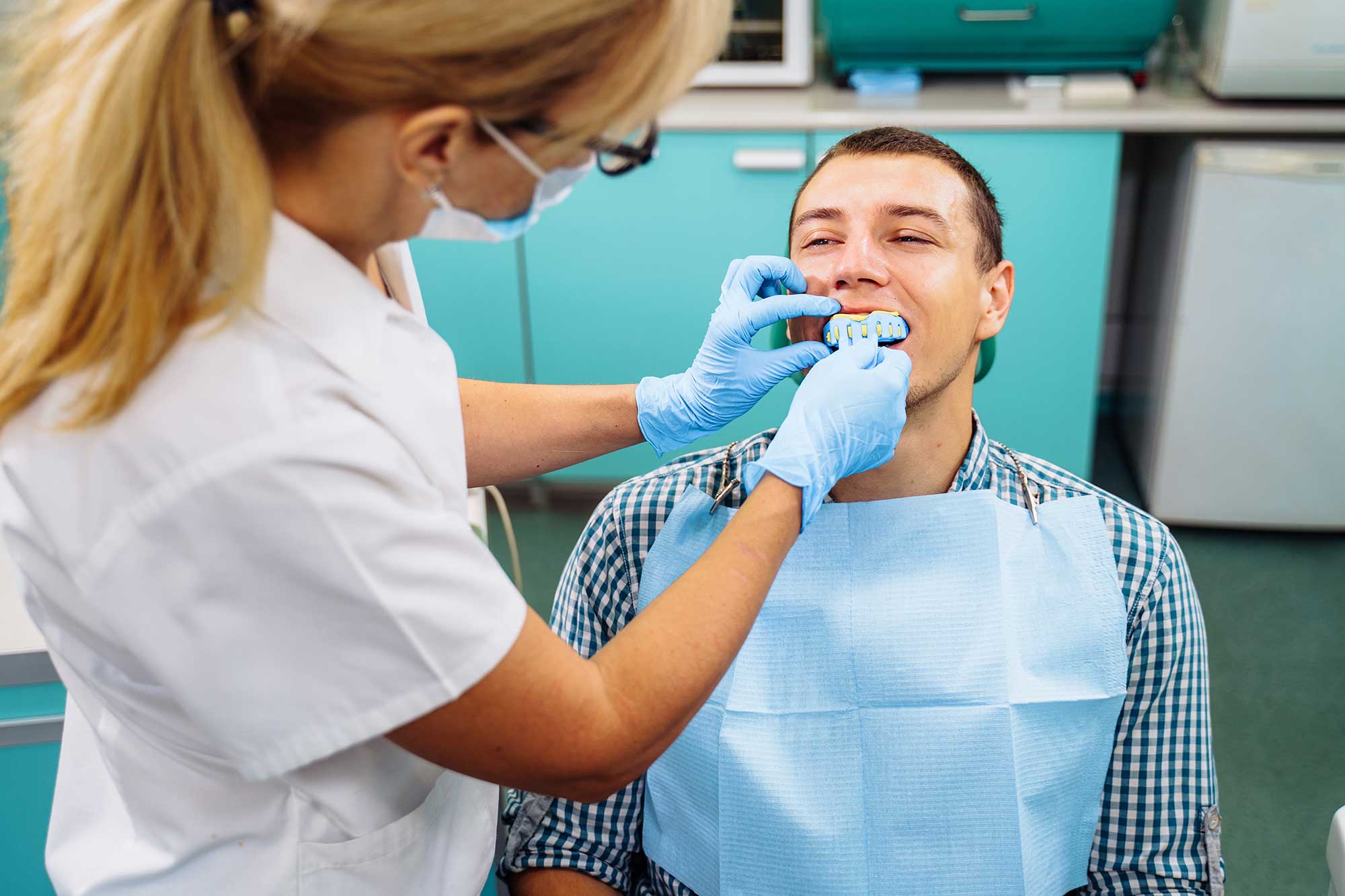 Man in dentist office getting a consultation on gum surgery image
