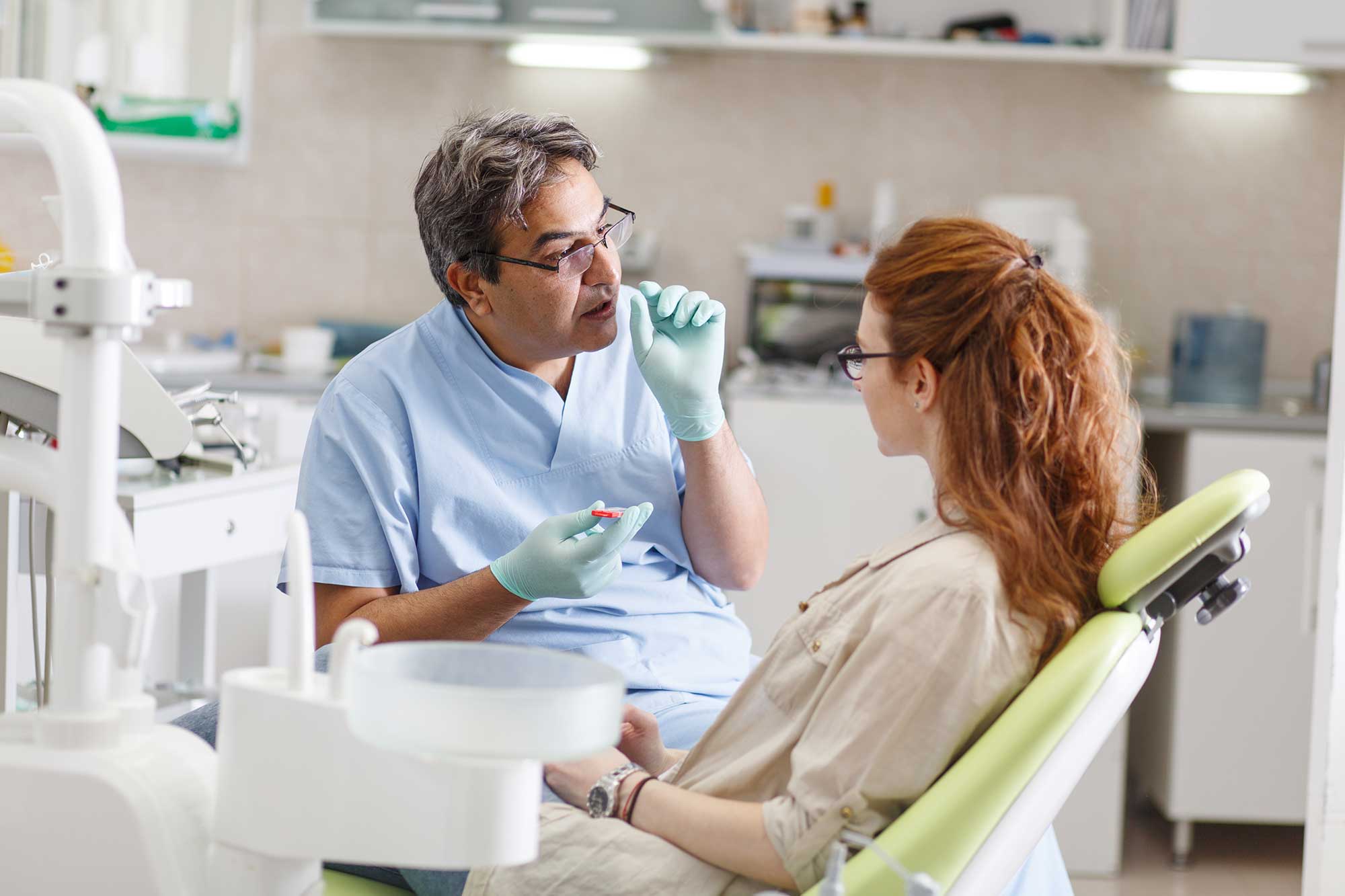 Patient consulting a dental professional in an office
