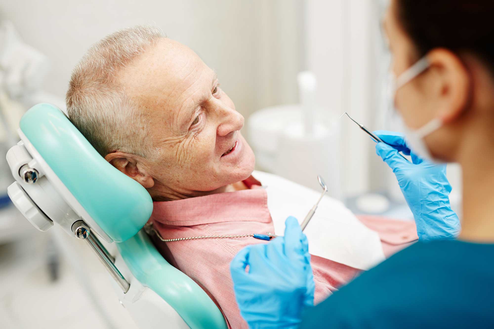 Patient in chair consulting with a dental professional