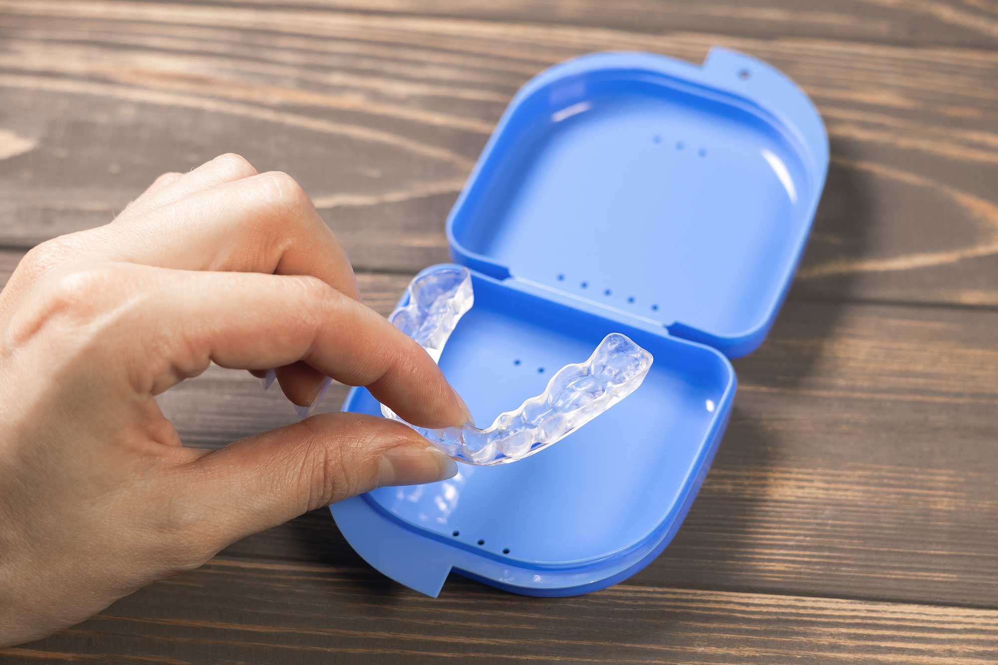 Person placing a mouthguard in its case
