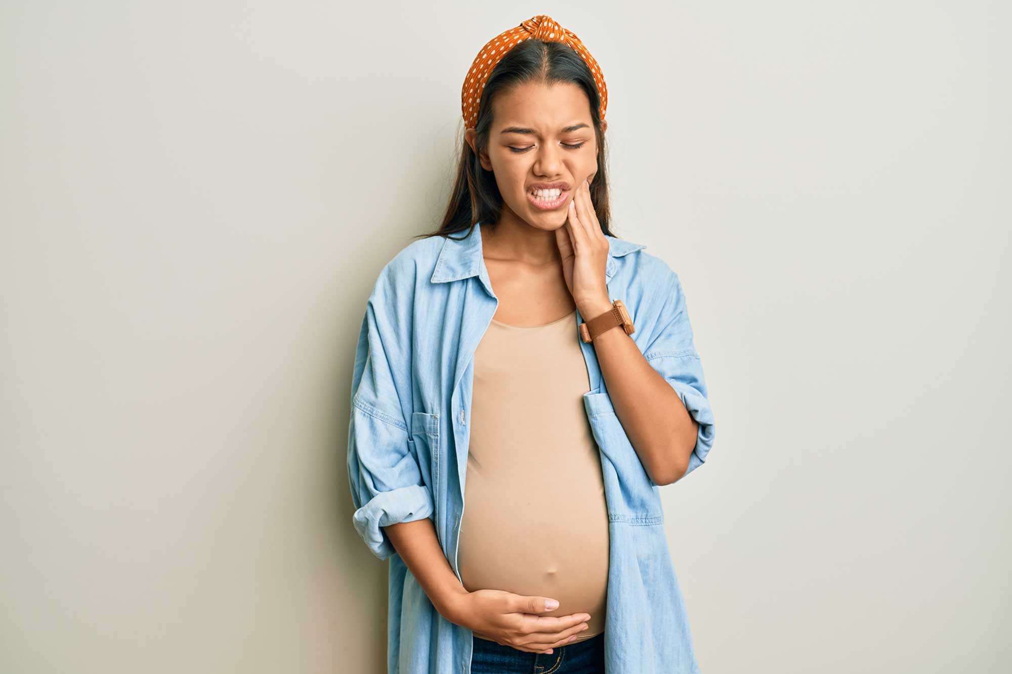Pregnant woman experiencing gum pain