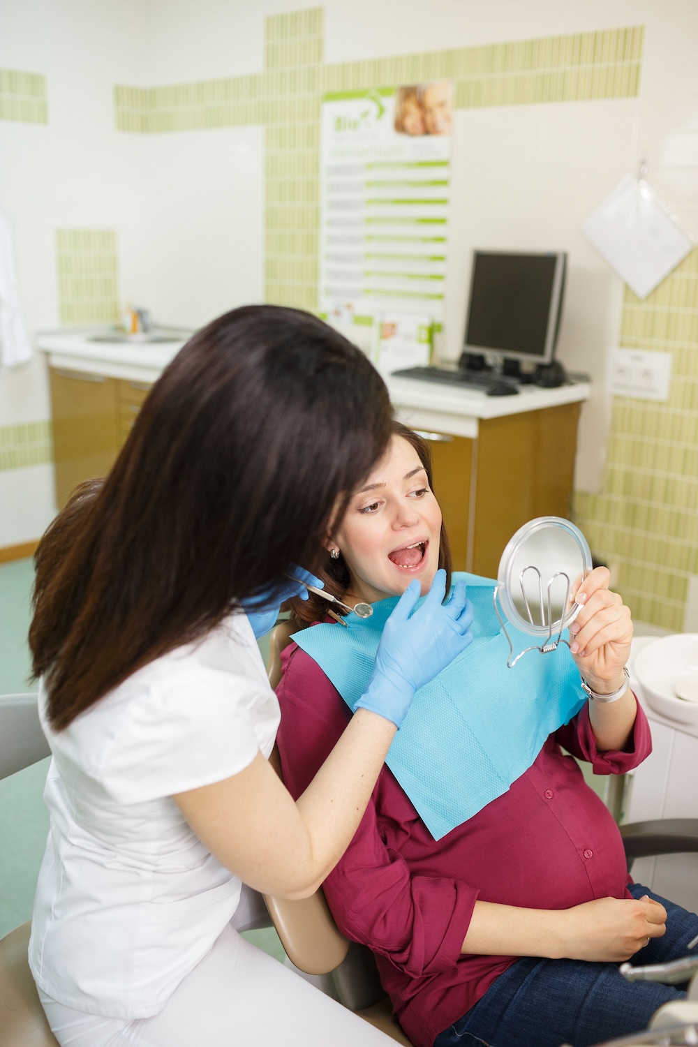 Pregnant women getting a treatment in a dentist’s office image