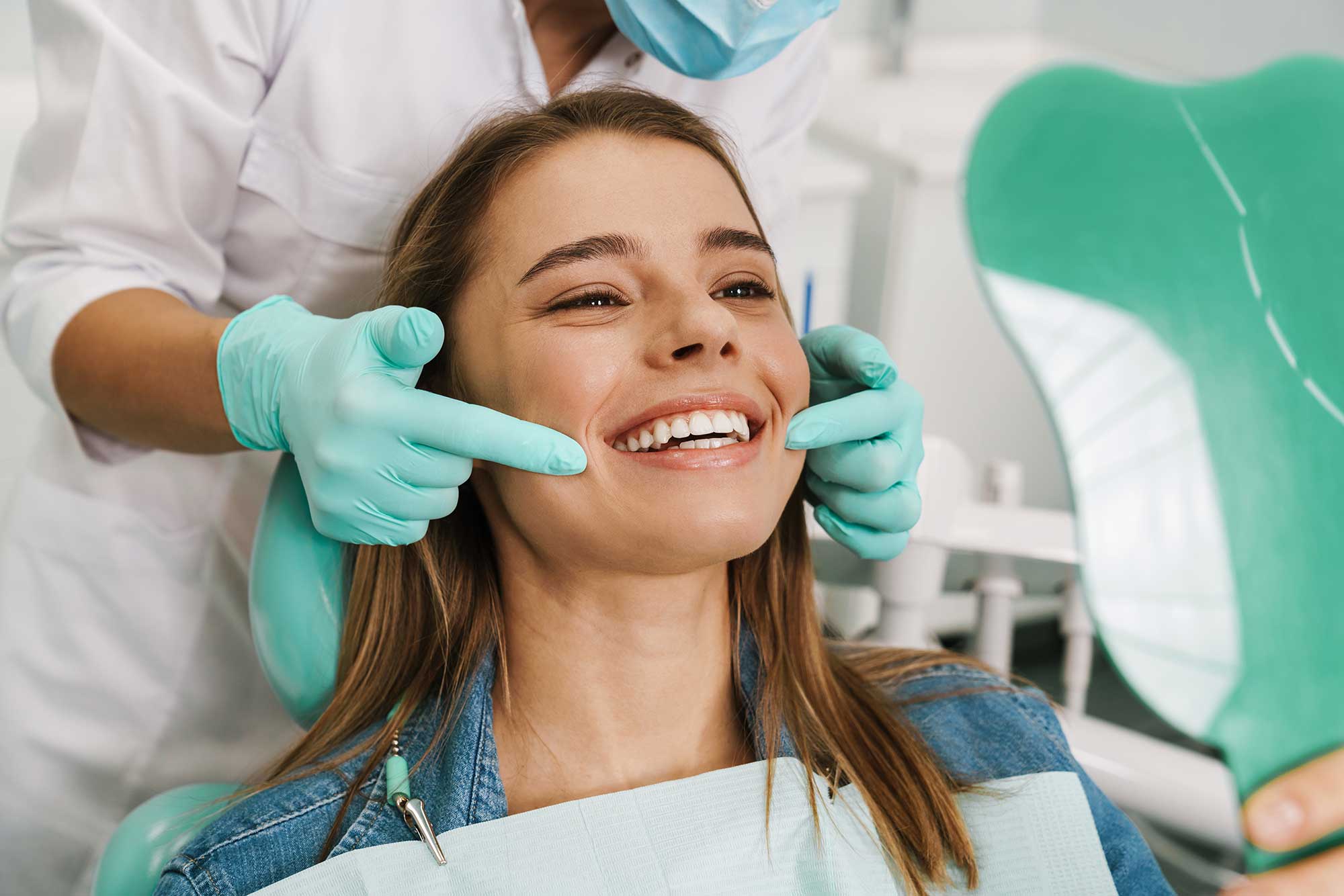 Smiling patient getting a consultation in a dentist’s chair Smiling patient getting a consultation in a dentist’s chair