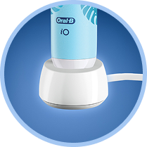 An iO toothbrush on top of a charger