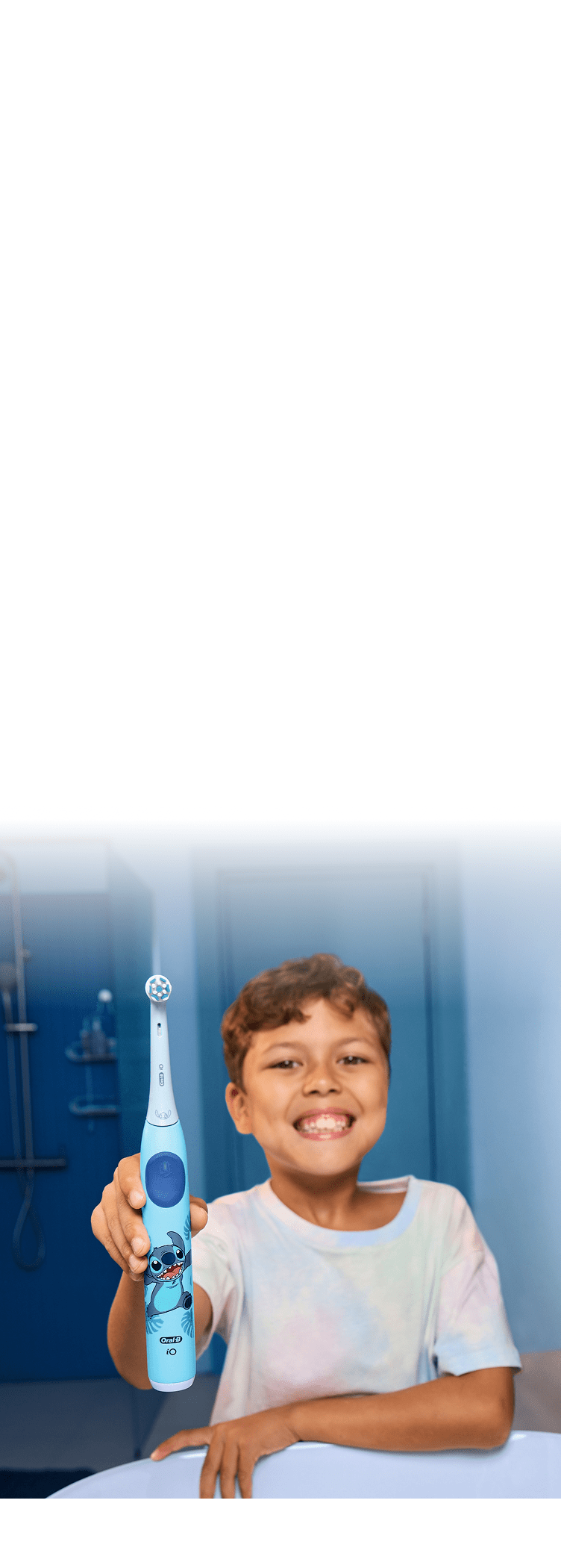 Smiling kid holding up a Disney Stitch toothbrush