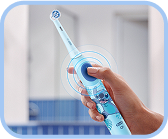 Two kids happily brushing their teeth together