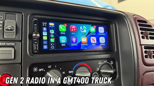 Aftermarket 1.5-DIN touchscreen radio installed in the center console of a Chevrolet GMT400 truck, displaying the Apple CarPlay home screen.