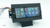 Aftermarket 1.5-DIN touchscreen radio for 2003–2006 GMT800 trucks or Chevy S10, shown on a workbench with the screen powered off, featuring a volume knob and front USB port.