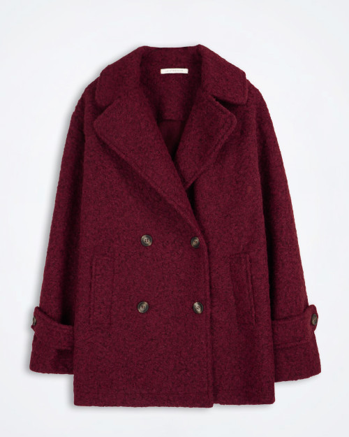 Front view of the Le Streghe double‑breasted bouclé coat showing the textured fabric and structured lapels.