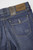 Detail shot of Bugatti men's medium wash denim shorts buttons and label – emphasizing brand and craftsmanship