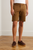 Men’s brown stretch‑cotton shorts by Block 11 shown on model for fit reference