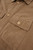 Close up of ribbed tan corduroy fabric texture and pocket detail