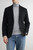 Male model wearing Brooksfield grey pure wool rollneck under a jacket styled with jeans.