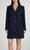Female model wearing the Sandro Ferrone single‑breasted navy blue coat in a full‑length hero shot, showing the clean tailored silhouette and textured navy fabric.