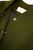 Close‑up of KAOS olive green cropped jacket showing silver snap buttons and “KAOS Jeans – Made in Italy” label inside collar.